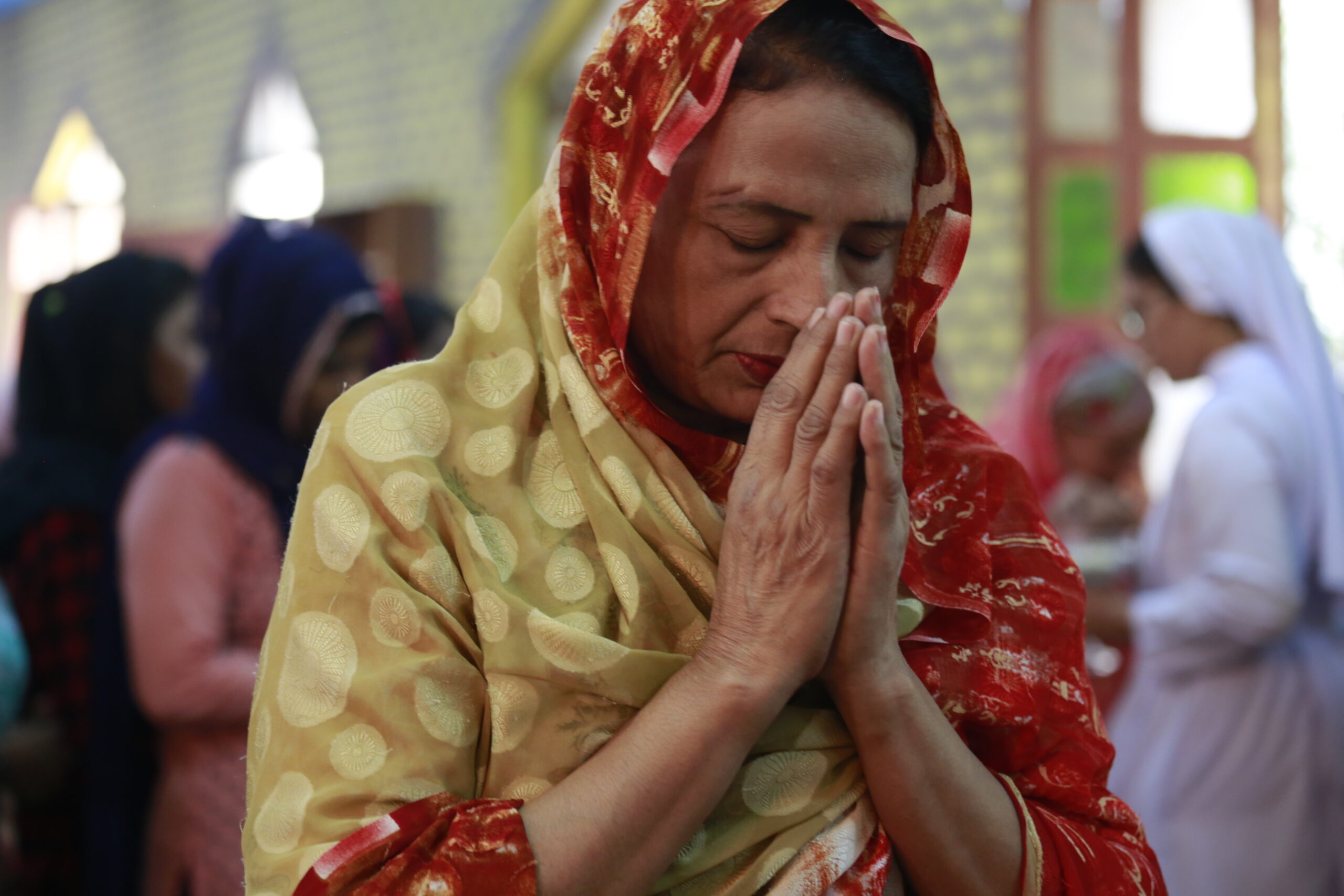A Pakistani Christian woman at prayer.